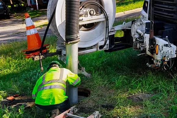 A man working on the side of a truck.