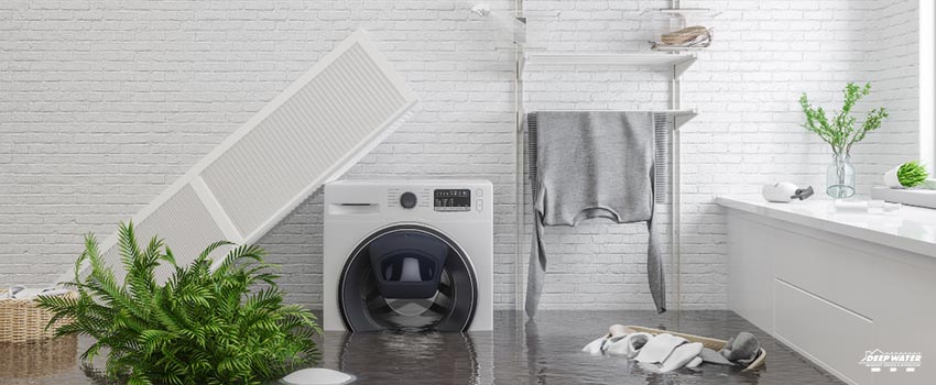 A white washing machine sitting on top of a wet floor.