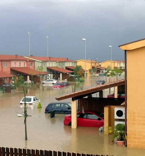A flooded area with cars parked in the street.