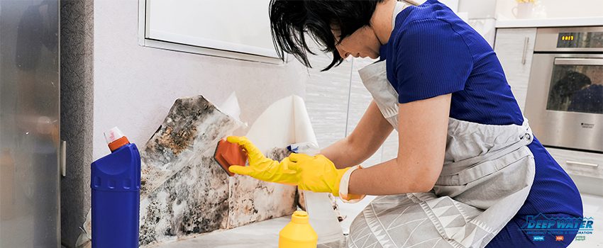 A woman in yellow gloves is cleaning the floor.