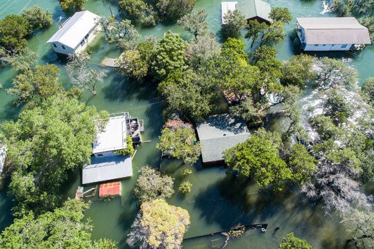 A flooded area with houses and trees.