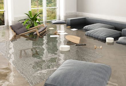 A living room flooded with water and furniture.