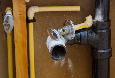 A pipe and faucet are attached to the wall.