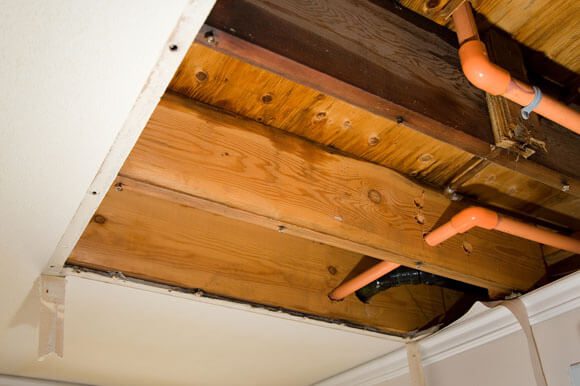 A wooden ceiling with some people standing underneath it