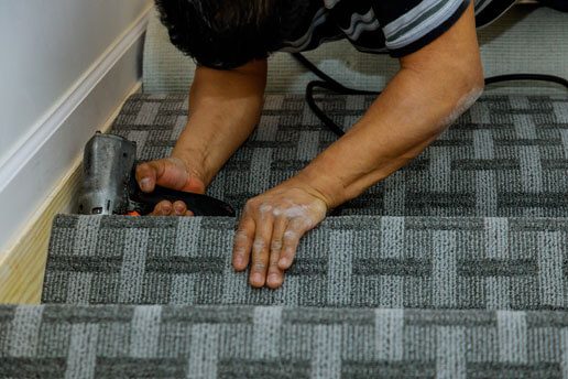 A person with their hands on the stairs