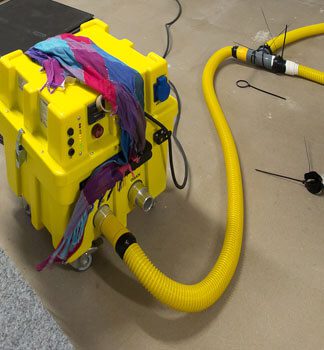 A yellow machine with wires attached to it.