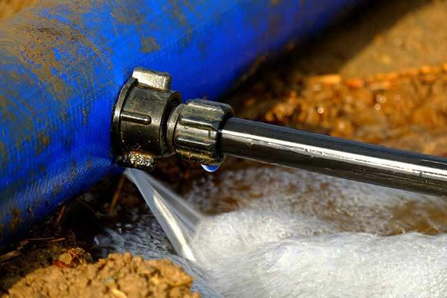 A close up of the water pipe being used to clean it