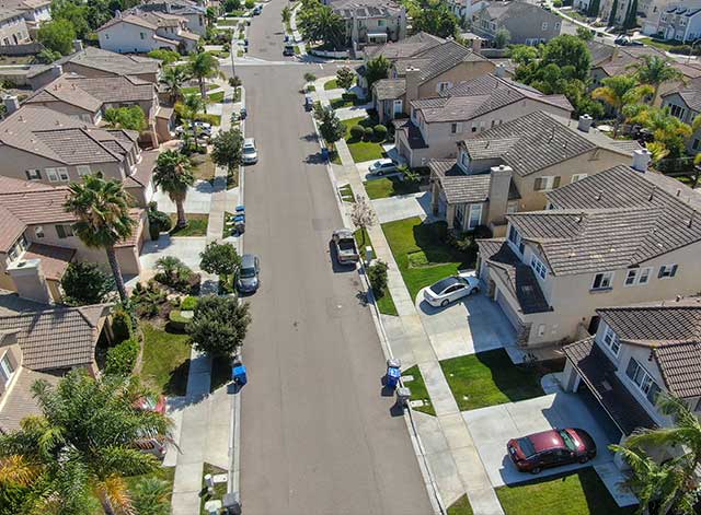 A street with cars parked on the side of it.